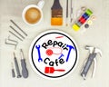 Repair Cafe logo on plate with a mug coffee surrounded by repair tools on table top, consumer activism