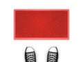Concept illustration showing shoes in front of a red door map.