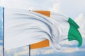 White flag on flagpole waving in the wind and flag of Cote Ivoire. Closeup view, 3D illustration.