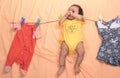 Absentminded Mother hangs child on clothesline Royalty Free Stock Photo