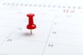 Concept image of a Calendar with red push pin. Closeup shot thumbtack attached. The words heart shape written on white Royalty Free Stock Photo