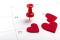 Concept image of a Calendar with red push pin. Closeup shot thumbtack attached. The words heart shape written on Royalty Free Stock Photo