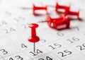 Concept image of a calendar with red push pins Royalty Free Stock Photo