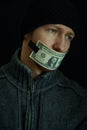 Concept image of corruption and bribery. Silent for money. Portrait of man with his mouth shut with one dollar banknote Royalty Free Stock Photo