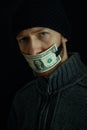 Concept image of corruption and bribery. Silent for money. Portrait of man with his mouth shut with one dollar banknote Royalty Free Stock Photo