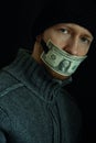 Concept image of corruption and bribery. Silent for money. Portrait of man with his mouth shut with one dollar banknote Royalty Free Stock Photo