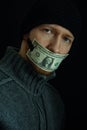 Concept image of corruption and bribery. Silent for money. Portrait of man with his mouth shut with one dollar banknote Royalty Free Stock Photo