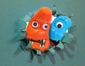 gruesome twosome paper burst hole monsters duo pair friends buddies googly eyes teeth Royalty Free Stock Photo