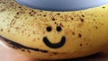 Concept image of a healthy plant food showing yellow banana fruit with smiley and normal black spots called bruises mean that the