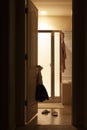 bathroom with girl clothes and bathrobe hanging and slippers on floor Royalty Free Stock Photo