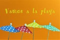 An concept Image of some umbrellas with the text, vamos a la playa = lets go to the beach Translation Royalty Free Stock Photo