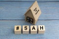 Concept image a wooden block and word - #SAH  STAY AT HOME Royalty Free Stock Photo