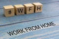 Concept image a wooden block and word - #WFH  WORK FROM HOME Royalty Free Stock Photo