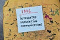 Concept of IMC - Integrated Marketing Communications write on sticky notes isolated on Wooden Table Royalty Free Stock Photo