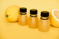 Concept Immune system strengthening. Bottles of lemon juice and fresh lemons. Isolated on yellow background. Royalty Free Stock Photo