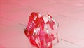 The concept of impersonation. A diamond spider in a shiny robe walks across the glossy tiles. Red pink color. Royalty Free Stock Photo