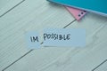 Concept of Impossible to possible write on sticky notes isolated on Wooden Table Royalty Free Stock Photo