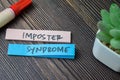 Concept of Imposter Syndrome write on sticky notes isolated on Wooden Table Royalty Free Stock Photo