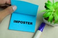 Concept of Imposter write on sticky notes isolated on Wooden Table Royalty Free Stock Photo