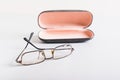 Concept of improper storage of old broken glasses on the background of a hard case on the table Royalty Free Stock Photo