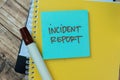 Concept of Incident Report write on sticky notes isolated on Wooden Table Royalty Free Stock Photo