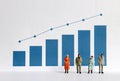 The concept of an increasing population of the elderly population. Blue bar graph with flow linear graph. Miniature older people.