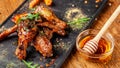 The concept of Indian cuisine. Baked chicken wings and legs in honey mustard sauce. Serving dishes in the restaurant Royalty Free Stock Photo