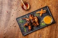 The concept of Indian cuisine. Baked chicken wings and legs in honey mustard sauce. Serving dishes in the restaurant Royalty Free Stock Photo