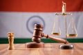 Concept of Indian justice system showing by using Judge Gavel, Balance scale on Indian flag as background