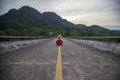 The concept of infinity and loneliness - a man sits on the road on the dividing strip