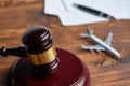 Concept of infringement of the rules of flying on an airplane next to the judge hammer