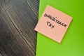 Concept of Inheritance Tax write on sticky notes isolated on Wooden Table Royalty Free Stock Photo