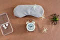 Concept of insomnia and nightmare disorder, flat lay. Sleeping mask, alarm clock and spiders. Unhealthy sleep