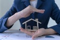 Concept of insurance and protect housing property. Insurance agents or appraisers protect the house model Royalty Free Stock Photo