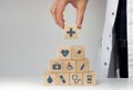 Concept of Insurance for your health, Hand hold wooden block with icon healthcare medical Royalty Free Stock Photo