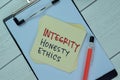 Concept of Integrity, Honesty and Ethics write on sticky notes isolated on Wooden Table Royalty Free Stock Photo