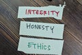 Concept of Integrity, Honesty and Ethics write on sticky notes isolated on Wooden Table Royalty Free Stock Photo