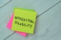 Concept of Intellectual Disability write on sticky notes isolated on Wooden Table