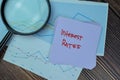 Concept of Interest Rates write on sticky notes isolated on Wooden Table Royalty Free Stock Photo