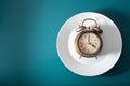 Concept of intermittent fasting, ketogenic diet, weight loss. alarmclock on a plate Royalty Free Stock Photo