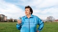 Concept of the International Day of Older Persons. Portrait of an elderly smiling woman in sports clothes, holding a Royalty Free Stock Photo