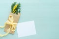 Concept of international women`s day Mimosa brunch in Kraft envelope bag on a blue background, bow of yellow silk with white blank