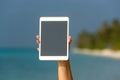Concept of internet and communication. blank empty tablet computer in the hands of women on the beach Royalty Free Stock Photo