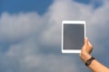 Concept of internet and communication. blank empty tablet computer in the hands of women on the sky Royalty Free Stock Photo