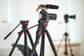 Concept interview, digital camera on a tripod with a microphone in the studio on a white background