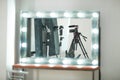 Concept interview, digital camera on a tripod with a microphone in the studio on a white background in the mirror reflection in