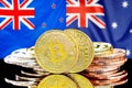 Bitcoins on New Zealand and Australia flag background Royalty Free Stock Photo