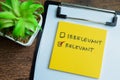 Concept of Irrelevant or Relevant write on sticky notes isolated on Wooden Table Royalty Free Stock Photo