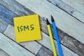Concept of ISMS write on sticky notes isolated on Wooden Table Royalty Free Stock Photo