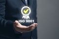 The concept of iso9001. Businessman scores business assessment ISO 9001, a quality management system (QMS).